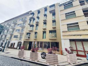 a building on a street with flowerpots in front of it at Hortas Residence 13 in Funchal