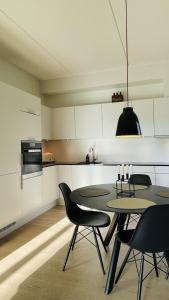 a dining room with a table and chairs in a kitchen at ApartmentInCopenhagen Apartment 1575 in Copenhagen