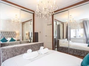 a bedroom with two beds and a large mirror at Holgate Lodge in York