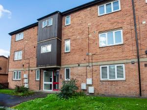 a large brick building with a red door at Holgate Lodge in York