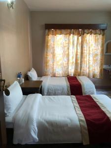 Postelja oz. postelje v sobi nastanitve Boudha Dungkar guest house