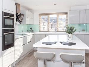 a kitchen with white cabinets and a white counter top at Holgate Lodge in York