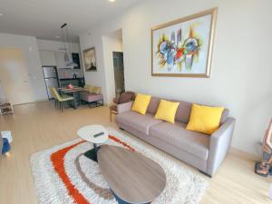 a living room with a couch and a table at Windmill Pemium 2-bedrooms at Genting High Floor Free WiFi in Genting Highlands