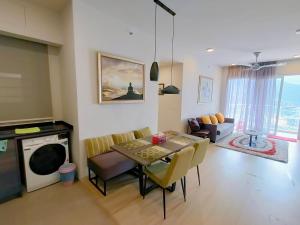 a living room with a table and a couch at Windmill Pemium 2-bedrooms at Genting High Floor Free WiFi in Genting Highlands