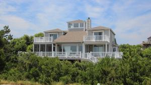a large white house on top of some trees at Oceanside, Priv Pool, poolside grilling, sun decks, SEA6, Morningstar in Duck