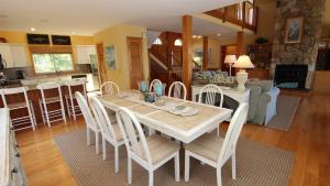 a dining room and kitchen with a table and chairs at Oceanside, Priv Pool, poolside grilling, sun decks, SEA6, Morningstar in Duck