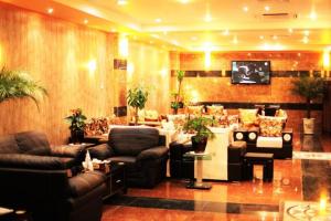 a large living room with couches and a tv at Malito in Erbil