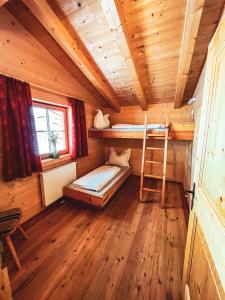 a cabin with a bunk bed and a ladder in it at Die Acherberg Alm in Oetz