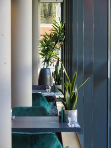 a room with two tables and potted plants at Future Inn Bristol in Bristol