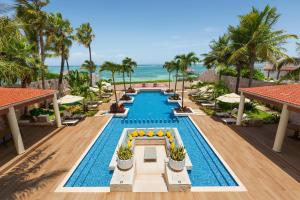 an infinity pool at the resort with the ocean in the background at Azul Villa Casa del Mar - Gourmet All Inclusive by Karisma in Puerto Morelos