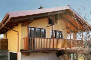 a house with a balcony on top of it at Il nocciòlo di Daisy in Graglia