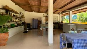 a kitchen and dining area of a house with a table at Airpoint Pousada Ecológica in Lençóis