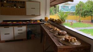 a counter with plates of food on it in a kitchen at Airpoint Pousada Ecológica in Lençóis +52 photos