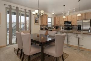 a kitchen with a dining room table and chairs at Trailhead Lodges Building 401 Unit 422 in Winter Park