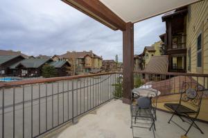 a balcony with two chairs and a table at Trailhead Lodges Building 401 Unit 422 in Winter Park