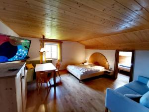 1 dormitorio con 1 cama y 1 mesa en una habitación en Garni Tschutscherhof, en Laion