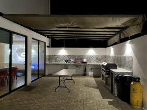 a kitchen with a table in the middle of a room at Casa Lycha in Tlayacapan