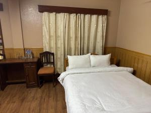 Postelja oz. postelje v sobi nastanitve Boudha Dungkar guest house