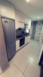a kitchen with a stainless steel refrigerator and appliances at Wild Olive Inn 62 in Windhoek