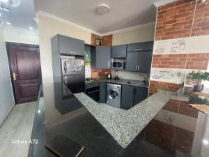 a kitchen with a counter top with a washer and dryer at شقة على النيل في البحر الاعظم in Cairo