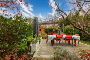 a dining table and chairs in a garden at Maison mitoyenne proche lac annecy in Annecy-le-Vieux