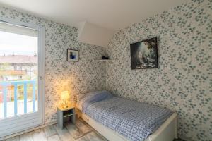 a small bedroom with a bed and a window at Maison mitoyenne proche lac annecy in Annecy-le-Vieux