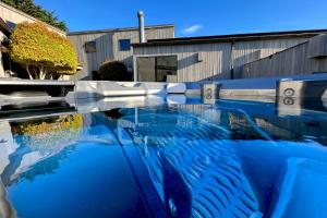 a pool of blue water in front of a building at Da Yaya House in Sea Ranch