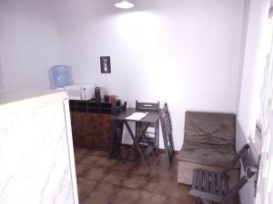 a small kitchen with a table and chairs in a room at ReGaGe in Florianópolis