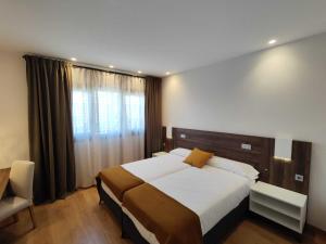 a bedroom with a large bed and a window at Alda Ruta Castilla in Palencia +50 photos