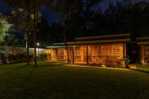 a house at night with a green lawn at Oxygen Palolem in Palolem