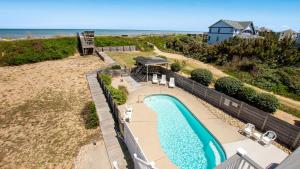 an aerial view of a swimming pool next to the beach at OCEANFRONT, Private Pool, Private Beach Access, Hot Tub, SSV124, Aint Life Grand in Sanderling
