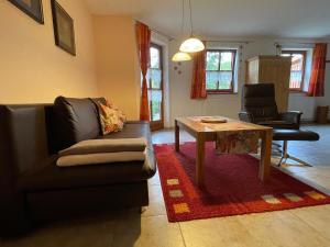 a living room with a couch and a table at Ferienwohnung Ott in Weißenburg in Bayern