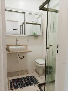 uma casa de banho com um WC, um lavatório e um chuveiro em Bebel 1108 em Florianópolis