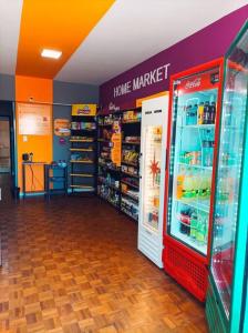 a store aisle with a home market refrigerator at Bebel 1108 in Florianópolis