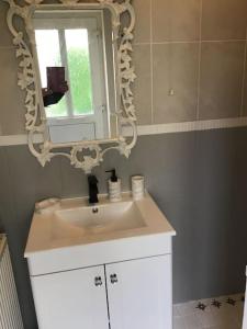 a bathroom with a sink and a mirror at The Miners Cottage in Blackwood