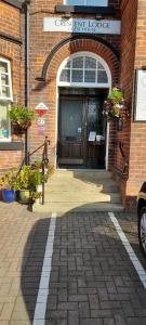 una entrada a un edificio de ladrillo con puerta en Crescent Lodge Guest House en Whitby