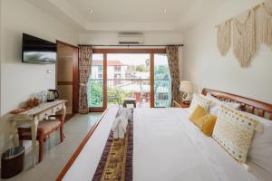 a living room with a large white couch and a table at Rendezvous Classic House in Chiang Mai