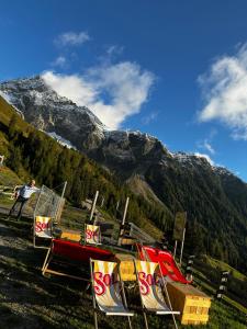 a group of signs in front of a mountain at Die Acherberg Alm in Oetz