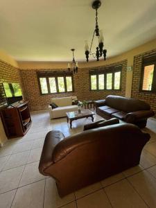 una gran sala de estar con sofás y una mesa. en Casa na serra de mulungu, en Mulungu