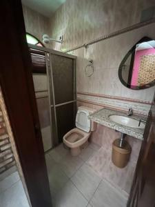 a small bathroom with a toilet and a sink at Casa na serra de mulungu in Mulungu