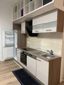 a kitchen with white cabinets and a sink at Le Mont-sur-lausanne: superbe studio ! in Le Mont-sur-Lausanne