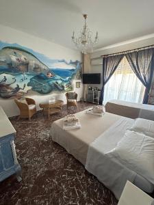 a bedroom with two beds and a painting on the wall at Antiquarium Messina in Messina