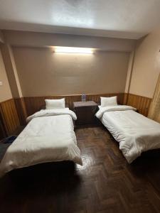 Postelja oz. postelje v sobi nastanitve Boudha Dungkar guest house