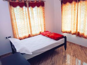 a small bed in a room with a window at Anna homestay in Chegāt