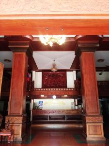 a lobby with wooden pillars and a chandelier at 万象莉莉酒店 in Vientiane