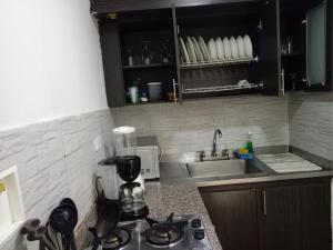 eine Küche mit einem Herd und einer Arbeitsplatte in der Unterkunft House Hotel Sweet Home 2 apartments in Medellín