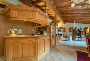 an open kitchen with a large island in a house at DEVA Achentaler Vitalhotel in Unterwössen