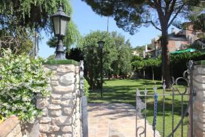 a stone fence with a street light on a stone wall at Cal Marques in Santa Oliva