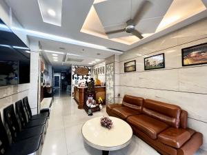 a living room with a couch and a table at Sao Mai Hotel in Ho Chi Minh City