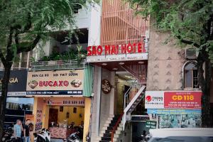 a group of signs on the side of a building at Sao Mai Hotel in Ho Chi Minh City